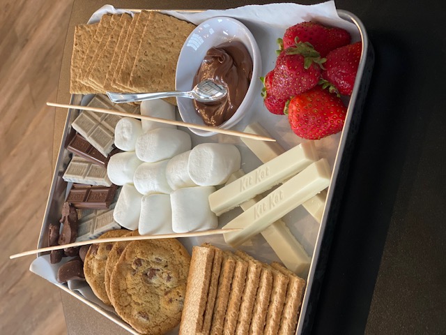 A tray filled with dessert treats and chocolate fondu to dip