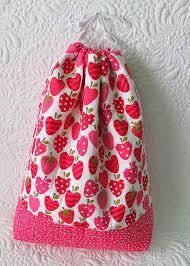 small draw string bag made with strawberry and apple patterned cloth