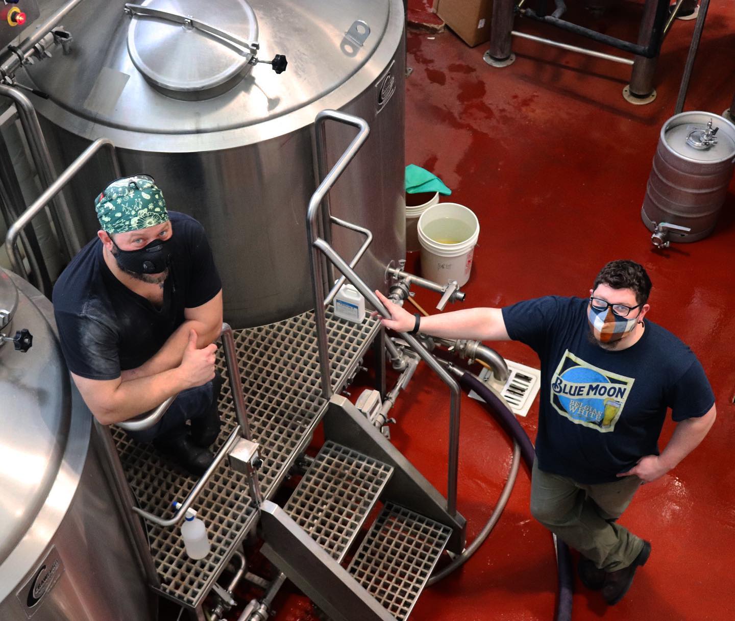 Two Brewers standing near brewing vessels at Pollyanna Brewing Company