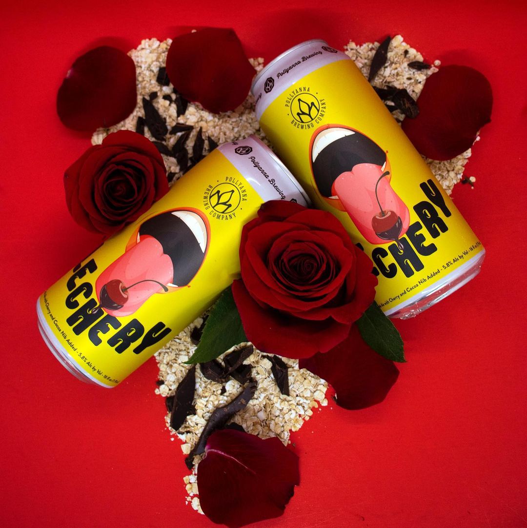 Cans of Lechery, surrounded by roses, cocoa nibs, and oatmeal.