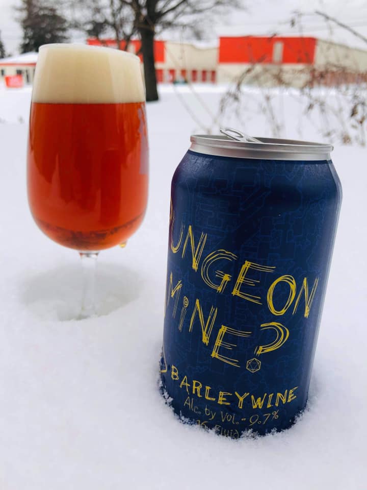 A can and glass of Your Dungeon or Mine Barleywine