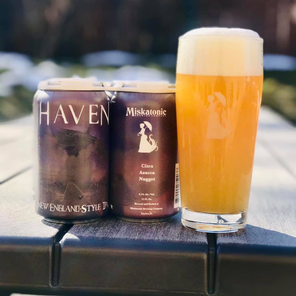 Four pack and a glass of Haven from Miskatonic Brewing Company