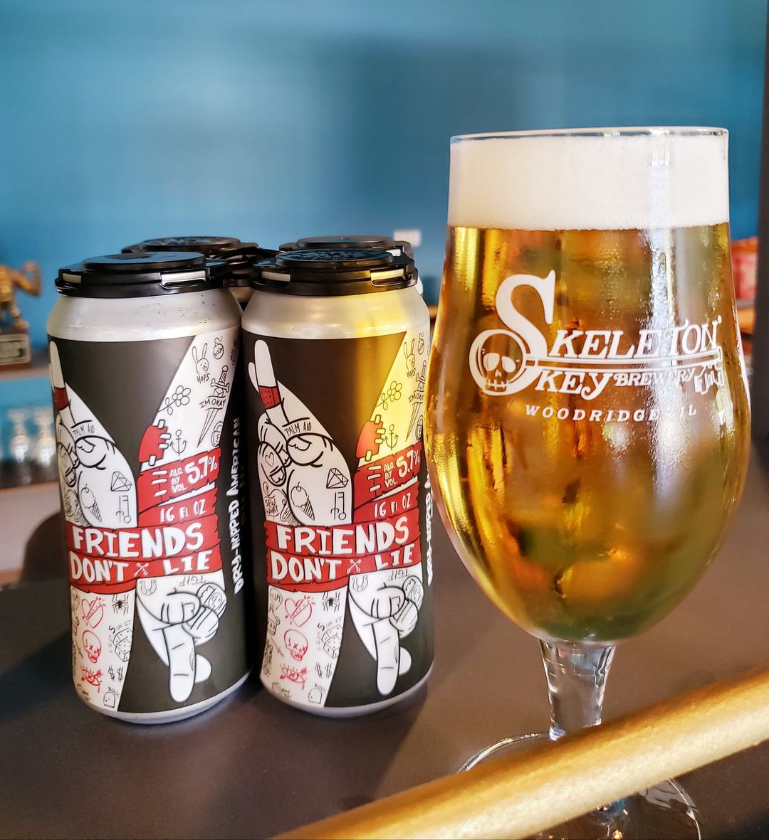 Cans and glass of Friends Dont' Lie by Skeleton Key Brewery