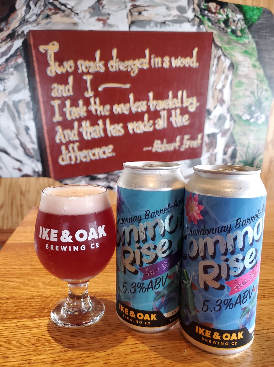 Glass and two cans of Ike & Oak Brewing's Common Rise