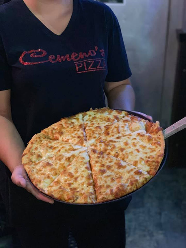 Server holding Cemeno's Cheese Pizza